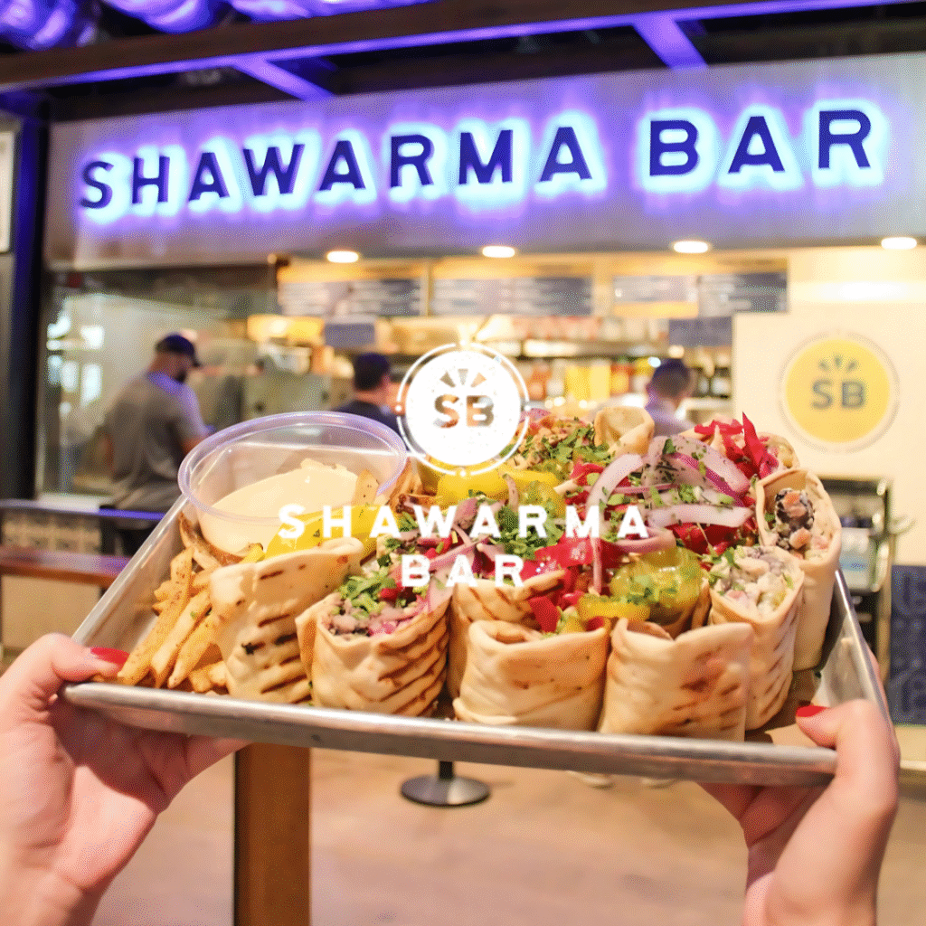 Tray of shawarma wraps and fries in front of Shawarma Bar at Legacy Food Hall in Plano, Texas.