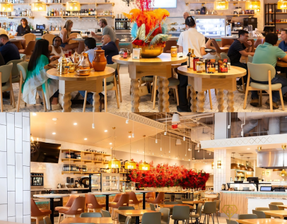Interior of Darna Mediterranean Market with central dining tables, floral displays, and a coffee and dessert counter.